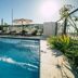 Tagüe in Gualeguaychú: outdoor pool with loungers and umbrellas in sunny rooftop setting