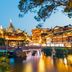 Hanting Hotel Lujiazui South Pudong Road in Shanghai with illuminated traditional-style buildings by water