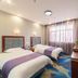 OYO Hexi Hotel in Zhangye guest room with two beds, window light, and wall-mounted TV