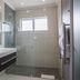 Sea Breeze Guesthouse in Swakopmund bathroom with glass shower, mosaic tile accents, and wall-mounted vanity