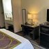 Super 8 by Wyndham Nebraska City room with TV, desk, mini fridge and microwave in Percival