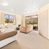 Shotover Lodge in Queenstown guest room with bed, seating area and mountain views