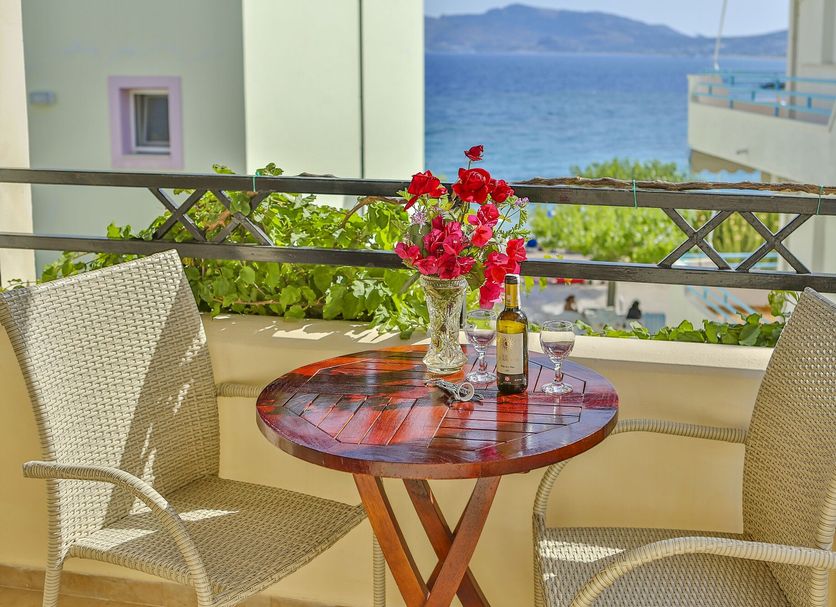 Haraki Mare Studios & Apartments in Rhodes balcony with table, chairs, flowers and sea view