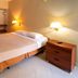 Solace by the Sea in Ponce hotel room with bed, nightstands and bathroom vanity area