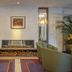 Glenroyal Hotel & Leisure Club in Maynooth lobby with fireplace, olive chairs and potted plants
