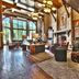Hotel Park City, Autograph Collection lounge with fireplace, leather chairs, tall windows and rustic wood beams in Park City