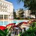 Grand Hotel Heiligendamm in Bad Doberan with outdoor pool and red loungers beside a grand white facade