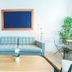 Romeo Hotel in San Juan lounge with blue sofa, coffee table, ladder shelf, and potted plant