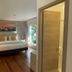 Casa Hotel Boyaca Real, Bogotá guest room with king bed, wood floors and large window