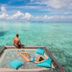Hurawalhi Island Resort in Komandoo: overwater net deck with couple over turquoise ocean