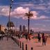 Cuatro Naciones in Barcelona with beachfront promenade, palm trees, and city skyline