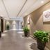 Home Inn Suzhou Mudu Ancient Town Lingyanshan Metro Station hallway in Suzhou with elevators and potted plants