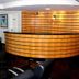 La Defense Apart Hotel in Montes Claros reception desk with wood-paneled curved front