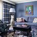 Graduate by Hilton State College lounge with blue sofa, patterned chairs, coffee table and artwork