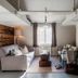 Nusfjord Village & Resort in Ramberg living room with sofas, window seat, and rustic wood wall