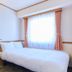 Toyoko Inn Kanda Akihabara room in Tokyo with a neatly made bed and bright window