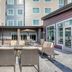 Residence Inn by Marriott Providence Lincoln courtyard patio with outdoor seating and tables between hotel buildings