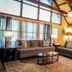 Pine Mountain Club Chalets Resort living room with vaulted wood ceiling and large windows