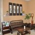 Oriental Hotel Dongguan lobby seating area with wooden sofa, chairs, coffee table and wall art