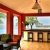 Pestana São Tomé lounge with bar stools, ocean view, and palm-framed poolside terrace in São Tomé