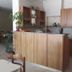 Nestor in Zacháro reception area with wood front desk and cabinet shelving