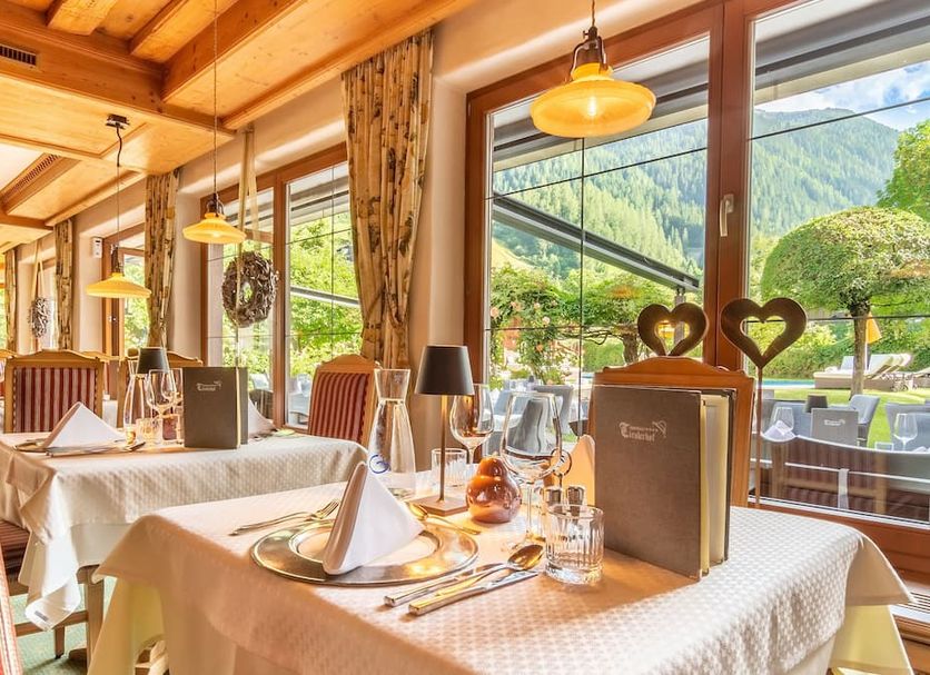Alpenhotel Tirolerhof dining room in Neustift im Stubaital with mountain and garden views