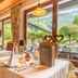 Alpenhotel Tirolerhof dining room in Neustift im Stubaital with mountain and garden views