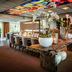 Fletcher Hotel Restaurant Boschoord in Oisterwijk lobby with floral display, bar and stained-glass ceiling