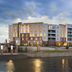 Hilton Garden Inn Sioux Falls Downtown exterior along the river at dusk