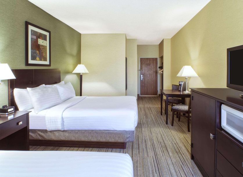 Country Inn & Suites by Radisson, Benton Harbor-St guest room with two beds, TV, microwave and desk