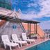 Lcs Hotel & Apartment in Phnom Penh rooftop pool with lounge chairs and city skyline view