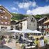 Hotel Valtellina in Livigno with outdoor café seating, alpine village buildings, and mountain backdrop
