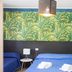 B&B Il Cavaliere in Santa Domenica guest room with blue beds and tropical leaf wall mural