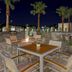 Element Ontario Rancho Cucamonga patio with fire pit seating, palm trees and planters in Ontario