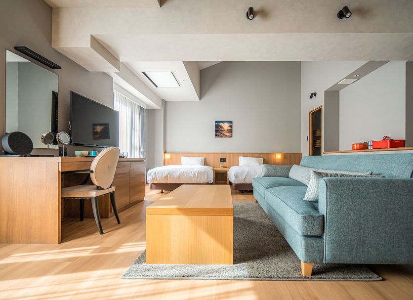 Guest room at Higashikawa Asahidake Onsen Hotel Bear Monte in Higashikawa with twin beds, sofa and desk