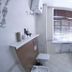 Rohat Hotel in Dushanbe bathroom with sink, mirror, toilet and tiled floor