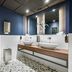 Leonardo Hotel Hannover Medical Park bathroom with double sinks, patterned tile floor and blue walls