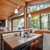 The Cabins at Terrace Beach, Ucluelet: cabin kitchen with large windows and forest views