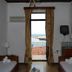 Gythion Hotel in Gytheio room with twin beds and balcony door opening to a sea view