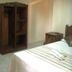 White Beach de Boracay guest room with bed, wardrobe, mini fridge and side table in Boracay