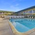 Motel 6 King City Ca outdoor pool with lounge chairs beside two-story motel buildings in King City
