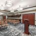 Best Western Plus Duncanville Dallas conference room with rows of chairs, podium, and projection screen