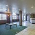 Motel 6 Bernalillo lobby with seating area, front desk, windows and tiled floor
