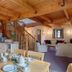 The Grove Cromer in Cromer: open-plan dining and lounge area with wooden beams and staircase