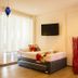 In Fashion Hotel & Spa in Playa del Carmen guest room with twin beds, wall TV, and floor-to-ceiling windows