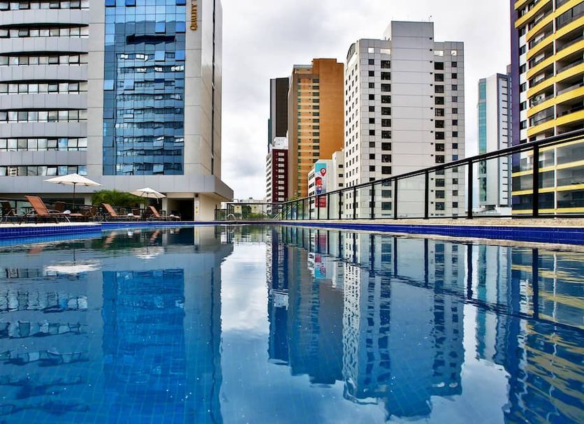 Quality Hotel & Suites Sao Salvador rooftop pool with city skyline views in Salvador