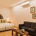 Quinta da Abelheira in Ponta Delgada guest room with twin beds, sofa, coffee table and wall art