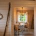 Nusfjord Village & Resort dining nook in Ramberg with small table, chairs and wood-burning stove