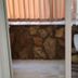Cann Hotel in Konakli room with sliding glass door to small table and stone wall balcony area
