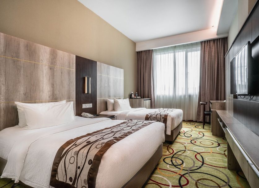 Ano Hotel in Miri room with two twin beds, large window, and wall-mounted TV